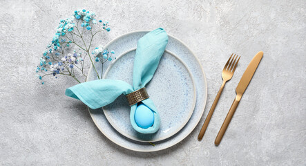 Beautiful festive table setting for Easter dinner on grey grunge background - obrazy, fototapety, plakaty