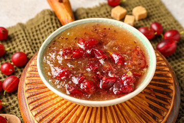 Bowl with tasty gooseberry jam on table