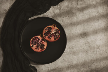 Pomegranates on plates. Healthy eating concept