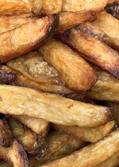 French fries with the potato skin on frying dark