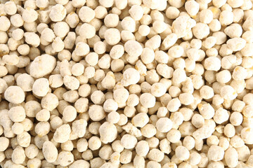 Closeup view of granular fertilizer as background