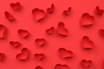 Abstract pattern of red paper hearts on color background