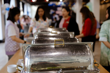 People hand grab buffet asian food in hotel seminar room