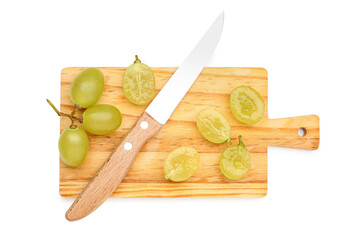 Wooden board with fresh green grapes on white background