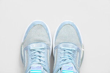 Stylish blue sneakers on grey background