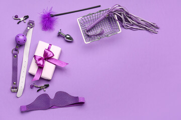 Shopping basket with sex toys and gift box on purple background