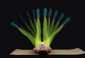 Young fitness trainer in motion on dark background