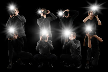 Group of photographers with cameras on black background. Paparazzi taking pictures with flashes