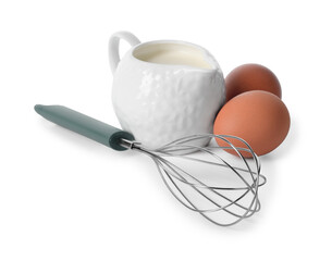 Whisk, raw eggs and jug of milk isolated on white