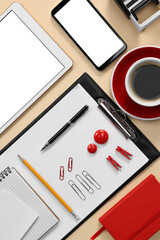 Modern tablet, smartphone, stationery and coffee on beige background, flat lay. Space for text