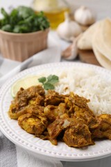 Delicious chicken curry with rice on table, closeup