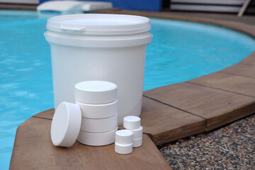 White chlorine tablets for swimming pool disinfection, pool water maintenance.	