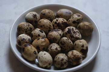 quail eggs in a white plate. proteins. allergen.