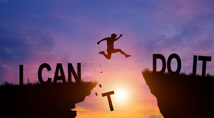 Silhouette man jumping over I can do it wording on cliffs with cloud sky and sunrise. Never give up, Good mindset, and Successful achievement Concept. - obrazy, fototapety, plakaty