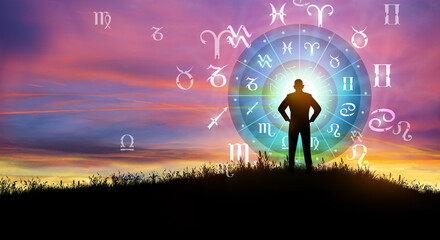 Astrological zodiac signs inside of horoscope circle. Illustration of Man silhouette consulting the Sun over the zodiac wheel and Sunrise background. The power of the universe concept.