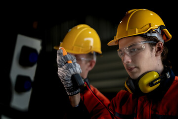 Fototapeta premium male engineer workers maintenance automatic robotic arm machine in a factory. worker checking and repairing automatic robot hand machine. technician worker check for repair factory machine.