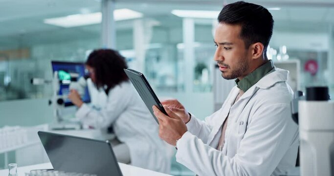 Scientist, man and tablet for laboratory research, DNA analysis and results in medical study at night. Young science expert or people in biotechnology, digital software or computer for test checklist