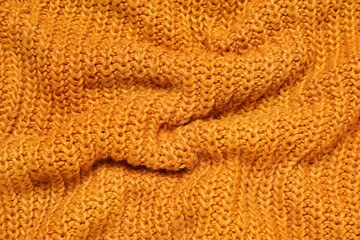 Texture of stylish knitted fabric with folds as background