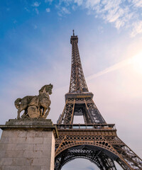 Fototapeta na wymiar The Eiffel Tower and The statue of Pegasus, an equestrian statue called Mercure Monte sur Pegase in Paris, France