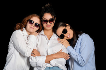 Beautiful young happy women in sunglasses on black background. Women history month