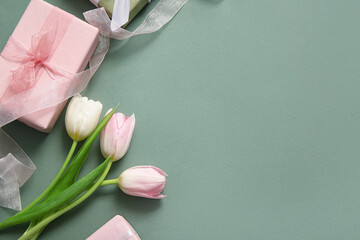 Composition with gift box and tulip flowers for Mother's Day celebration on grey background