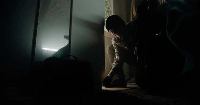 Young worker hesitating to plug in electrical wiring