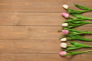 Beautiful tulips on wooden background. International Women's Day