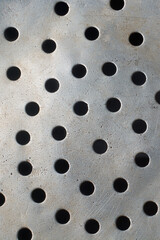 abstract of old dirty scratched metal surface with round holes background, mesh of holes or...