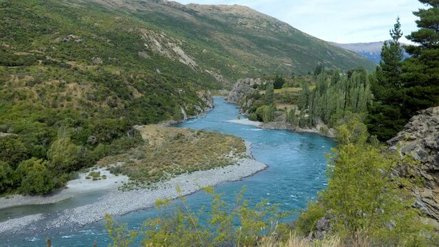 Kawaraw river flows between mountains at Roaring Meg, Queenstown, New Zealand