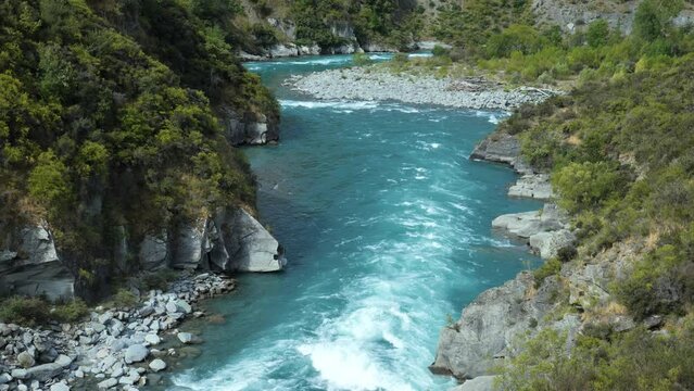 Kawaraw river flows between mountains at Roaring Meg, Queenstown, New Zealand, close-up