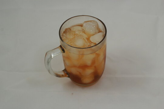 sweet iced tea in a glass on a white background