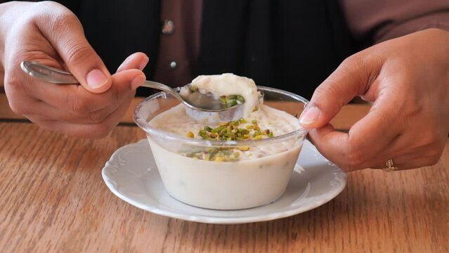 women eating rice pistachios pudding ,