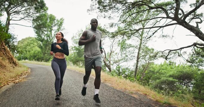 Man, woman and running on mountain for fitness with personal trainer for exercise, performance or cardio. Athletes, outdoor and marathon or workout practice for sport or health, wellness or nature