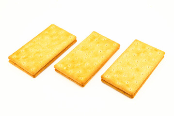 many delicious saltine crackers on white background