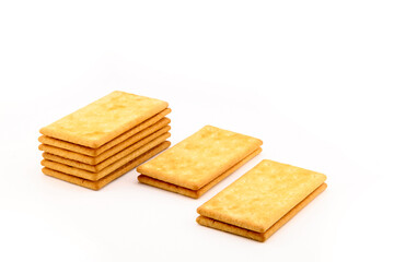 many delicious saltine crackers on white background