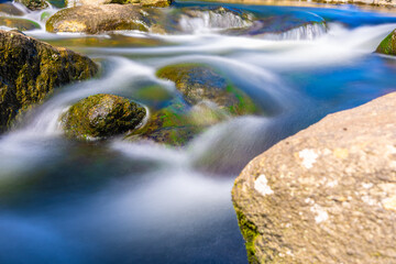 Soft effect of tumbling water in rocky stream at McLaren Falls