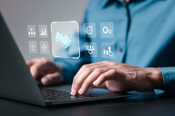 Agreement, partnership or deal concept. Businessmen use laptop with virtual handshake icon for...