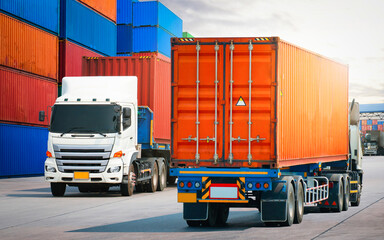 Semi trailer Trucks on The Road and Stacked of Containers Cargo Shipping. Distribution Cargo Port. Handling of Logistics Transportation Industry. Cargo Container ships, Freight Truck Import-Export.