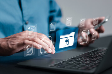 Corporate data management system concept. Businessman use laptop with virtual screen of Documents icon for document secure confidential access. Personal data and corporate personal data protection.