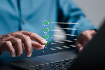 Businessman using laptop to take online survey on checklist and filling online form for Business...