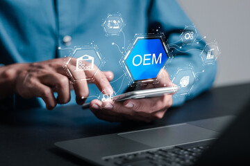 OEM or Original Equipment Manufacturer concept. Businessman with virtual screen of OEM icon for strategies for planning product and brand production. Support to reduce cost and production time.