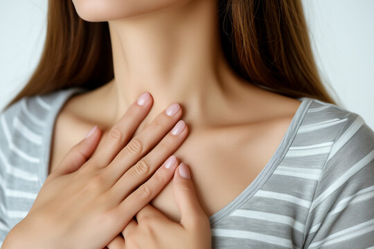 Young woman pressing on chest or her throat having heart attack, having heart attack or painful cramps, heart disease, isolated on white background.