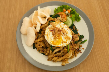 Kwetiaw or Kwetiau, fried rice noodles with shrimp, egg and vegetables. 