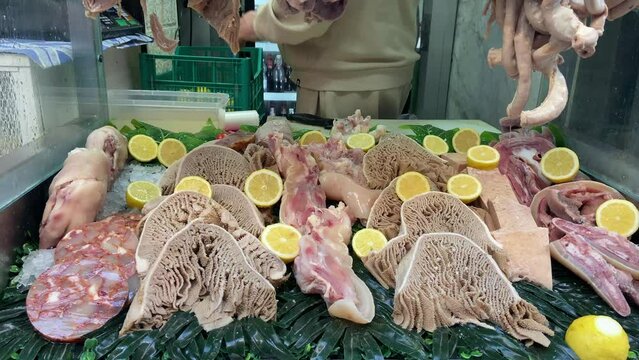 Worker selling animal tripe in street shop of Naples, Italy.