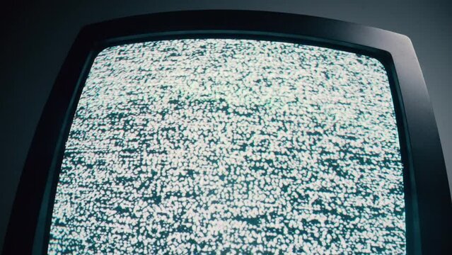 Retro television with static, blinking screen, dark backdrop