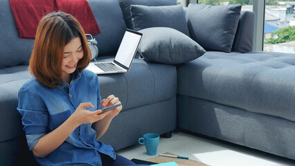 Smiling face asian woman holding smartphone with E-commerce Shopping online website Reading Online Article, Blog, vlog. Young Woman hands holding phone technology lifestyle. Woman using smart phone. © aFotostock
