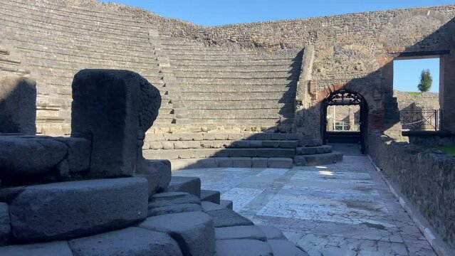 Old stone roman theatre preserved in Pompeii archeological site.