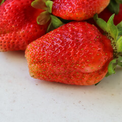 Large ripe red juicy strawberries on a white background