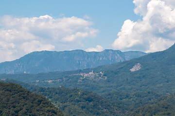 Scenic view of remote mountain village seen from Castle of Ragogna (Ruvigne) in Valeriano (Pinzano al Tagliamento), Friuli Venezia Giulia, Italy. Small town embedded in alpine hills in Italian alps