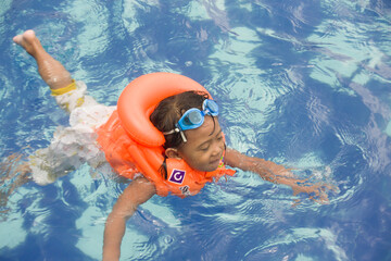 Girls who swim and play in the water wear life jackets